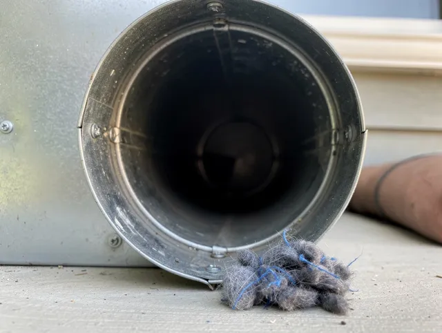Powell Dryer Vent Cleaning technician using specialized equipment to clear severe dryer vent blockage in Powell